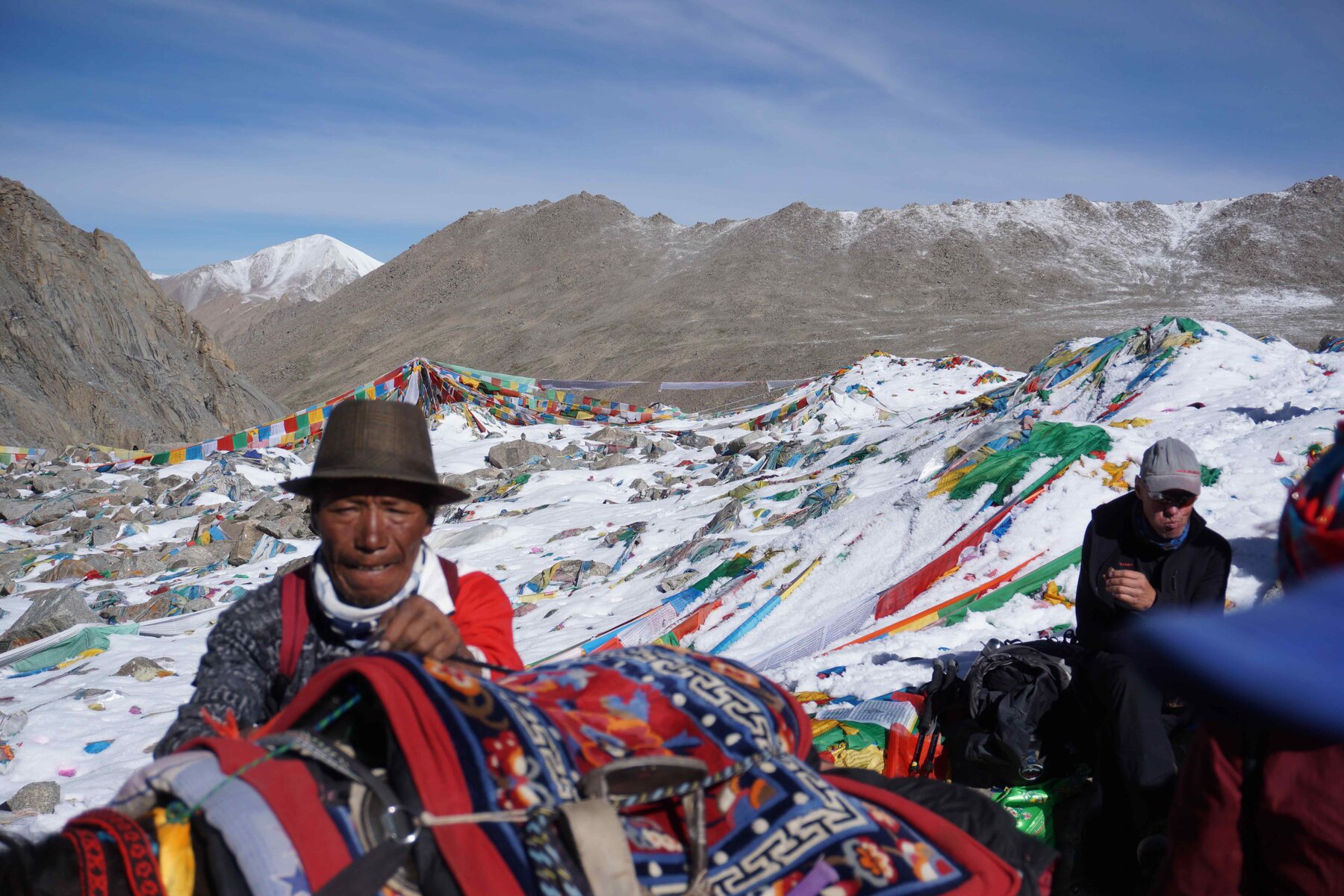 Dolma La pass, covered in snow and prayer flags, at 5,800 metres